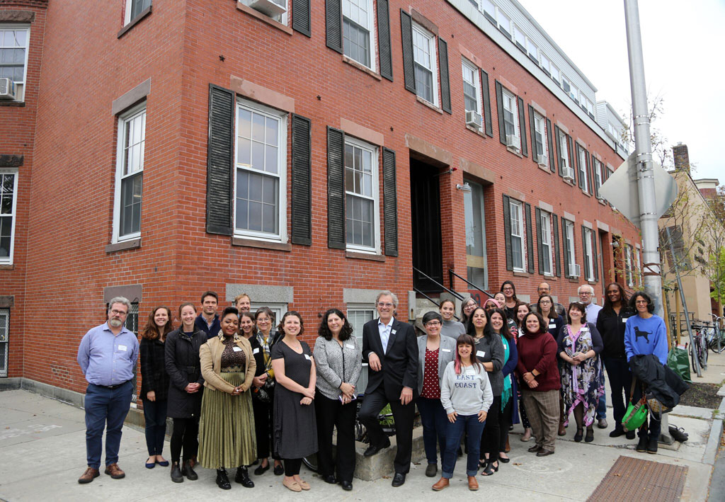 Photo of the tenants at 93-99 Bishop Allen Drive in front of the building's brick facade