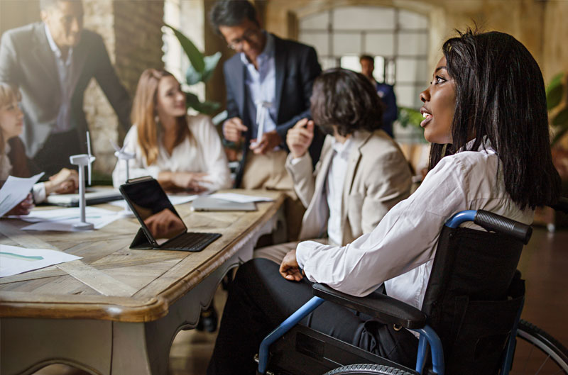 Woman in wheelchair at meeting